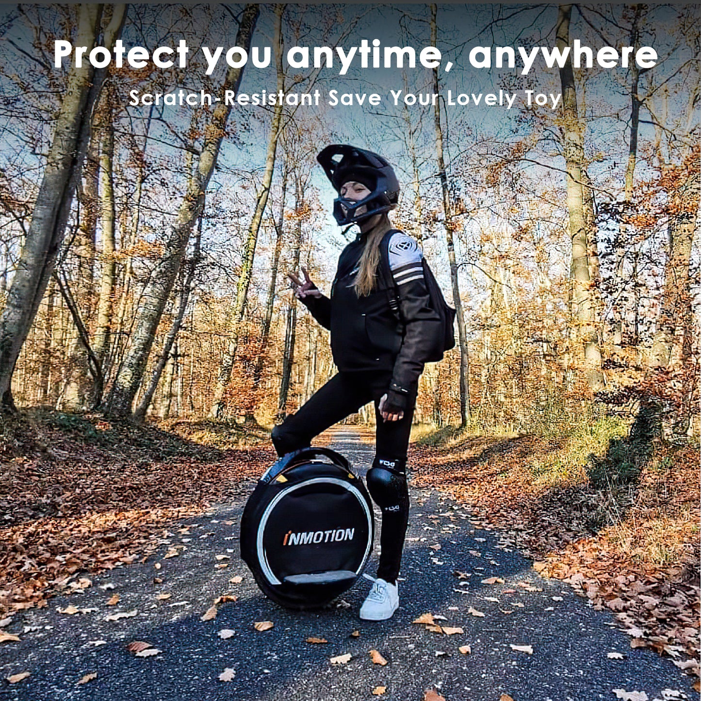 Person in protective gear standing next to a black unicycle cover in a forest.